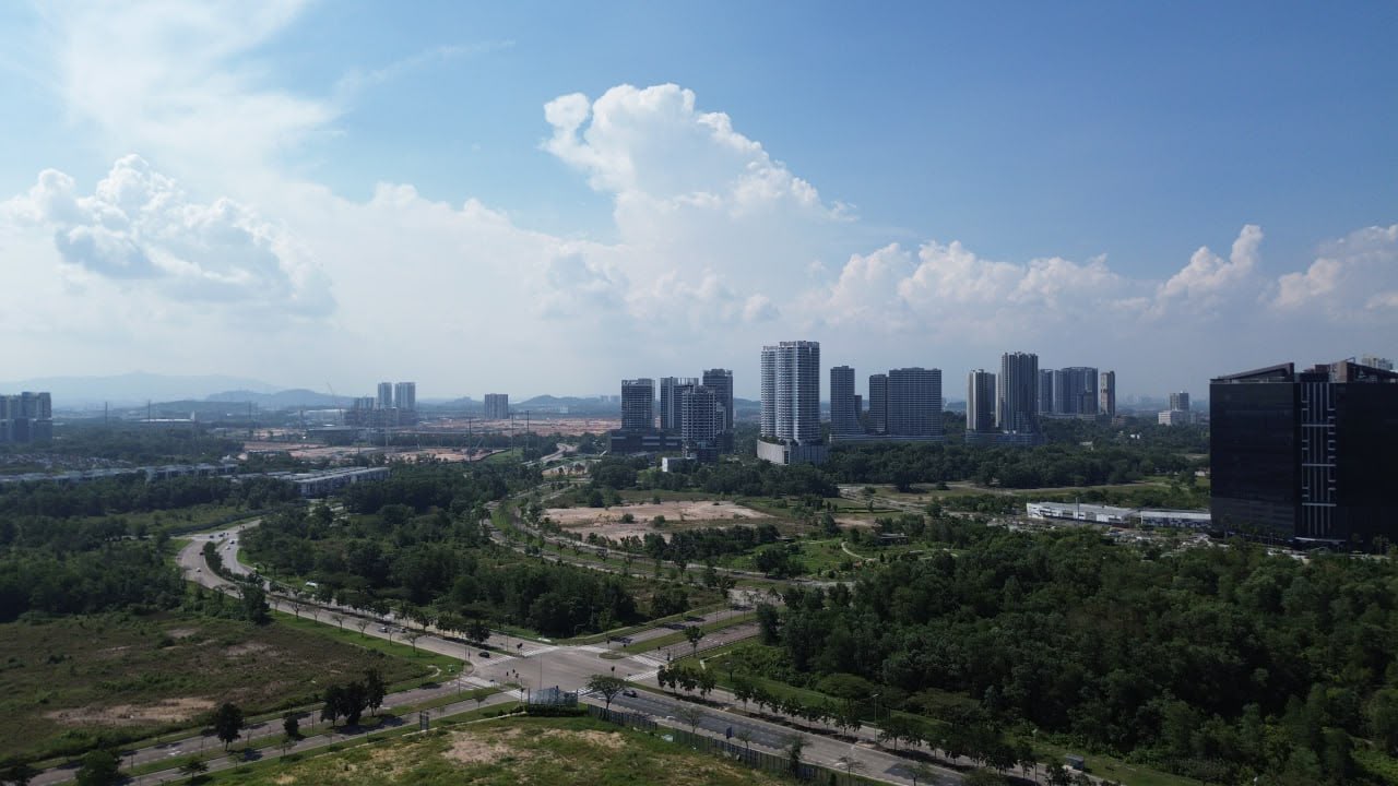 Medini Iskandar Puteri skyline with residential towers and undeveloped land